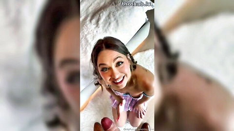 Riley Reid smiling close-up in pink low-cut top showing cleavage