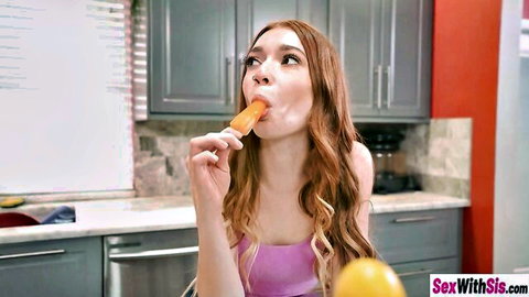 Horny teen with long brown hair teasingly sucks popsicle