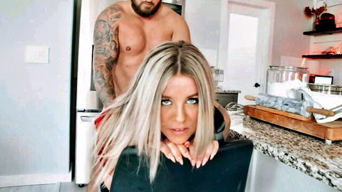 Tattooed muscular hunk pulls blonde babe's long hair roughly from behind in steamy kitchen tease