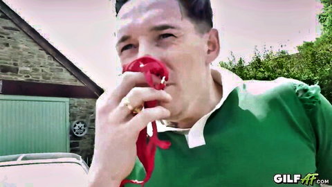 Mature Caucasian man in green jersey wiping face with red cloth outdoors on GILF.tv