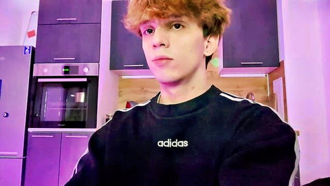 Cute freckled redhead twink in black Adidas hoodie posing in purple-lit kitchen webcam solo