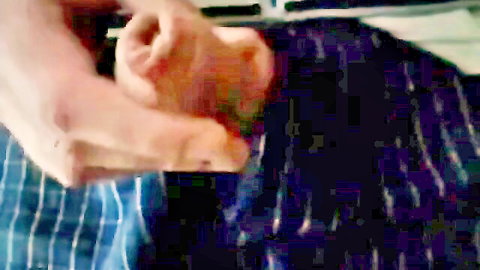 Man's pale hands gripping red foot toes in amateur foot fetish closeup