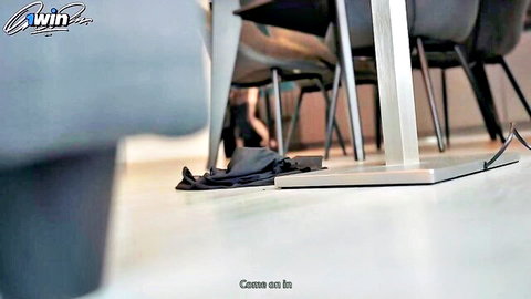 Blurry office lounge with dropped black clothes on floor teasing post-sex scene