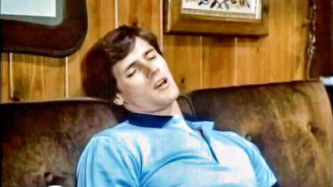 Vintage stud throws head back moaning in ecstasy on retro couch