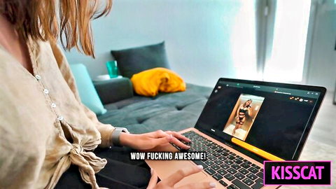 Brunette woman excitedly viewing sexy photo on laptop screen
