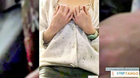 Busty housewife teasing huge tits with hands under open white cardigan in amateur striptease