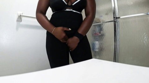 Ebony curvy woman in black lingerie holding pee desperation in bathroom