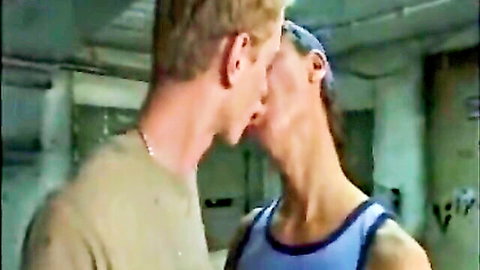 Two men passionately kissing, one blonde nuzzling neck in intimate embrace