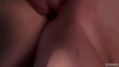 Close-up of wet shaved pussy with pink labia spread in dim red light