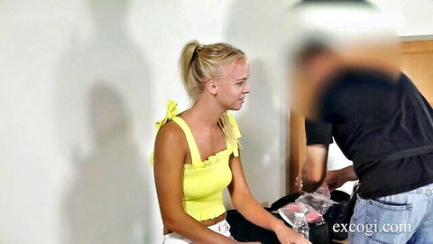 Blonde babe in skimpy yellow bow top and white skirt sits with legs apart teasing for rough sex