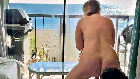 Blonde MILF bent over for doggy style sex on balcony with ocean view