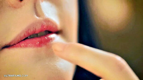 Amelia Riven teasing glossy lips with finger, Eastern European beauty