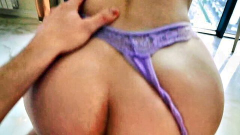 Diana Rider's curvy ass exposed as hand pulls purple thong aside