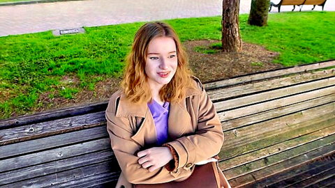 Diana Rider in trench coat on outdoor bench, teasing for stranger hookup