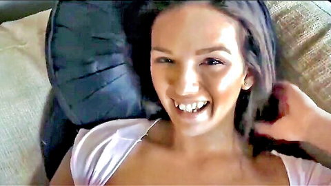 Shae Summers smiling seductively with cleavage in pink top, teasing exposure
