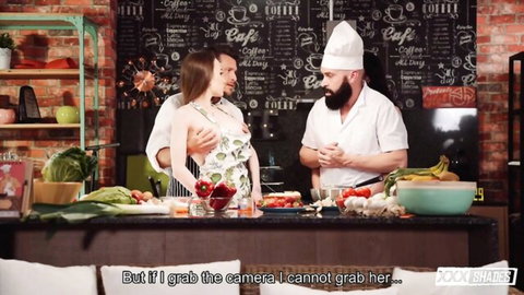 Brunette with big tits in revealing dress flirts with two chefs in steamy kitchen threesome tease