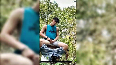 Young muscular guy outdoors stroking his hard cock solo handjob in woods