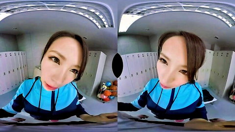 Cute Japanese woman in blue hoodie squats smiling teasingly in locker room VR POV