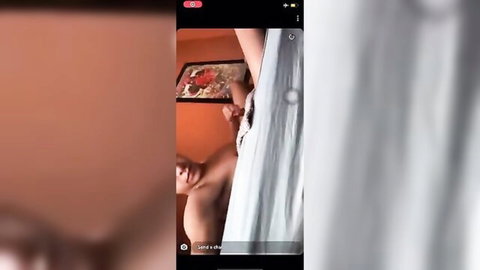 Woman lifts thin white sheet teasing brown-skinned man's erect cock and balls in live stream