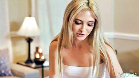 Seductive blonde babe in tight white strapless top showing deep cleavage teasing in bedroom