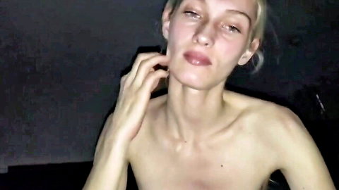 Blonde amateur woman topless, scratching face in dim light blowjob video thumbnail