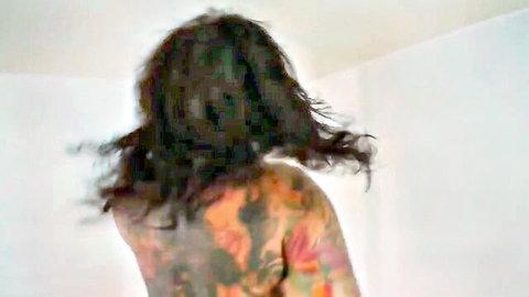 Tattooed brunette babe flaunting her colorful nude back tattoos from behind
