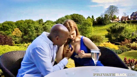 Busty redhead in blue dress gets tits groped by black man during romantic outdoor garden champagne moment