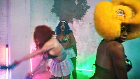 Dakota Payne and curvy ebony women dancing in colorful outfits in porn music video