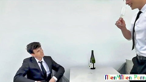 Angel Dario Garcia in suited job interview gay scene with champagne