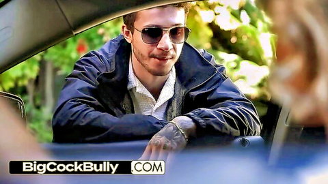 Tattooed guy in sunglasses smiles at redhead woman leaning into open car door