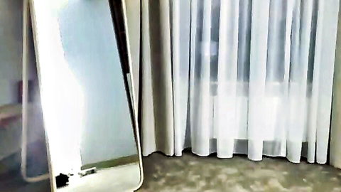 Empty bedroom interior with tall mirror and white sheer curtains in soft lighting