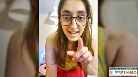 Princiana smiling in glasses and red top, pointing on live cam show