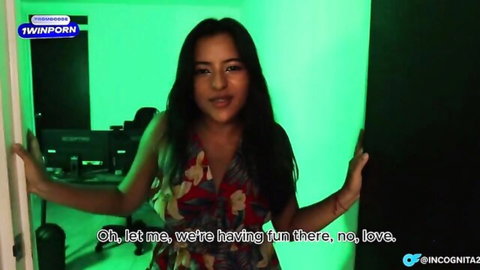 Sexy Asian babe in floral dress spreads arms teasing in green lit studio