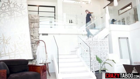 Curvy MILF in black top climbs modern glass stairs in luxury home teasing big ass