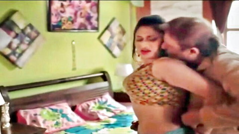 Hot Indian babe in colorful top passionately embraced by man from behind exposing cleavage and navel