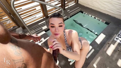 Emma Rose in zebra bikini gives poolside blowjob to black hotel worker