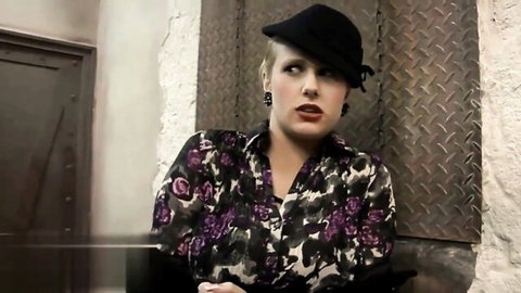 Pornstar A. Wicky in floral blouse and beret, seductive pose