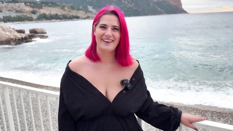Venus, 25yo pink-haired French beauty in cleavage-baring black dress seaside
