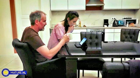 Brunette Vera V. with older Steve Steel at table in teasing pose