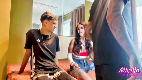 Young slim friends in casual clothes chilling at home before naughty fun
