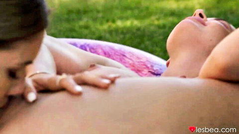 Two charming teen lesbians in intimate outdoor embrace, hand on breast