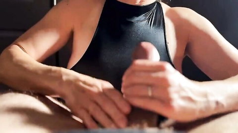 Hot wife in black swimsuit gives intense handjob closeup