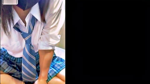 Japanese schoolgirl in uniform sitting with legs spread