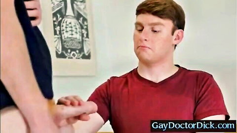 Redhead guy in red shirt has wrist gripped by partner in black top during gay foreplay