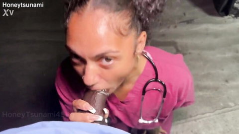 Ebony nurse in pink scrubs kneels sucking huge brown cock with stethoscope on