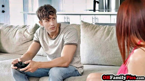 Redhead teen in pink top teases muscular gamer on couch before oral sex