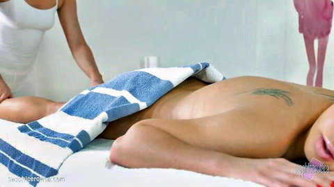 Blonde masseuse sensually massages naked man's bare back thighs and ass under towel in erotic session