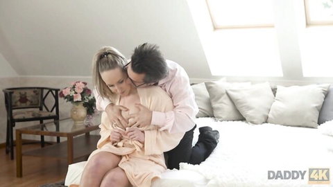 Jennifer Simons in open robe exposing breast, kissed by man in intimate Daddy 4K scene