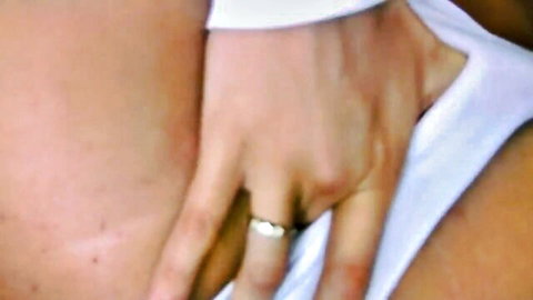 Wife's pale hand with diamond wedding ring gripping cock through white sleeve closeup
