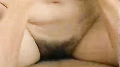 Close-up of hairy pussy spread wide open exposing wet pink labia and vagina